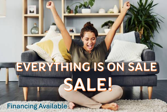 Woman celebrating on her area rug while on her laptop.