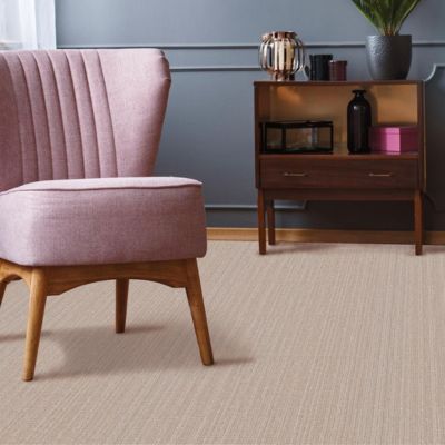textured beige carpets in a living room with upholstered pink chair