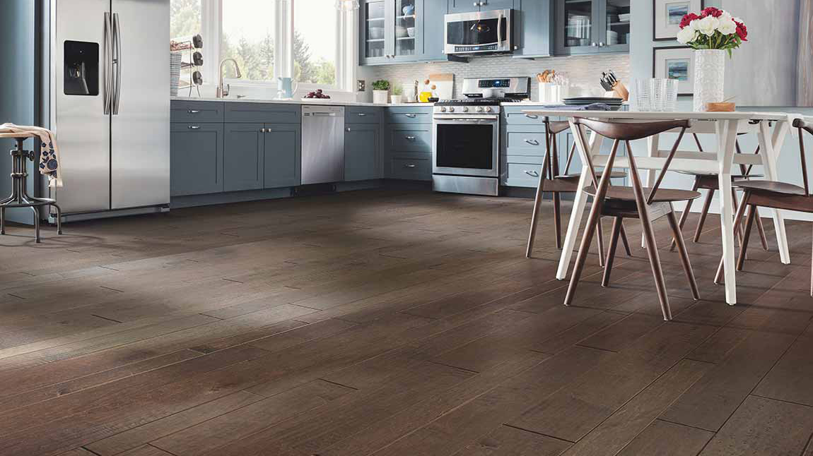 Hardwood floors in a kitchen with blue cabinetry